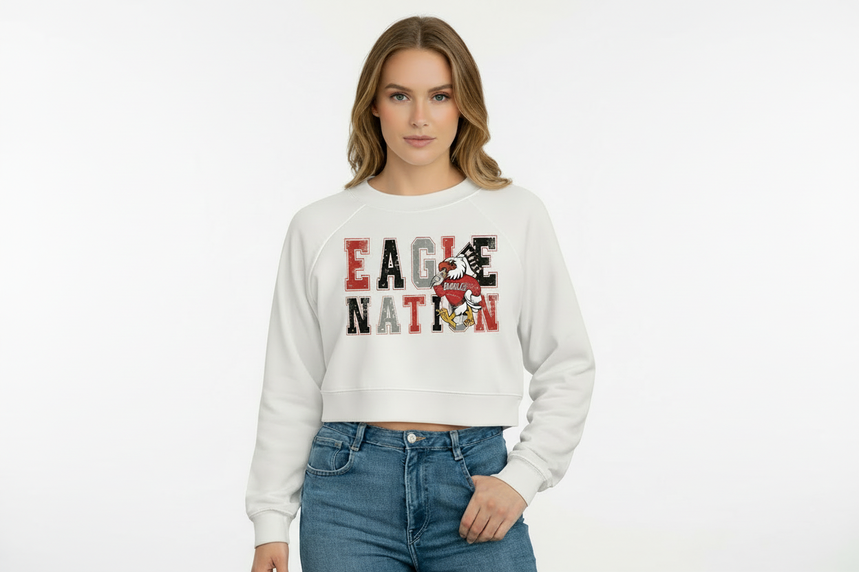 Woman wearing a white sweatshirt with 'Eagle Nation' text and logo on a plain background