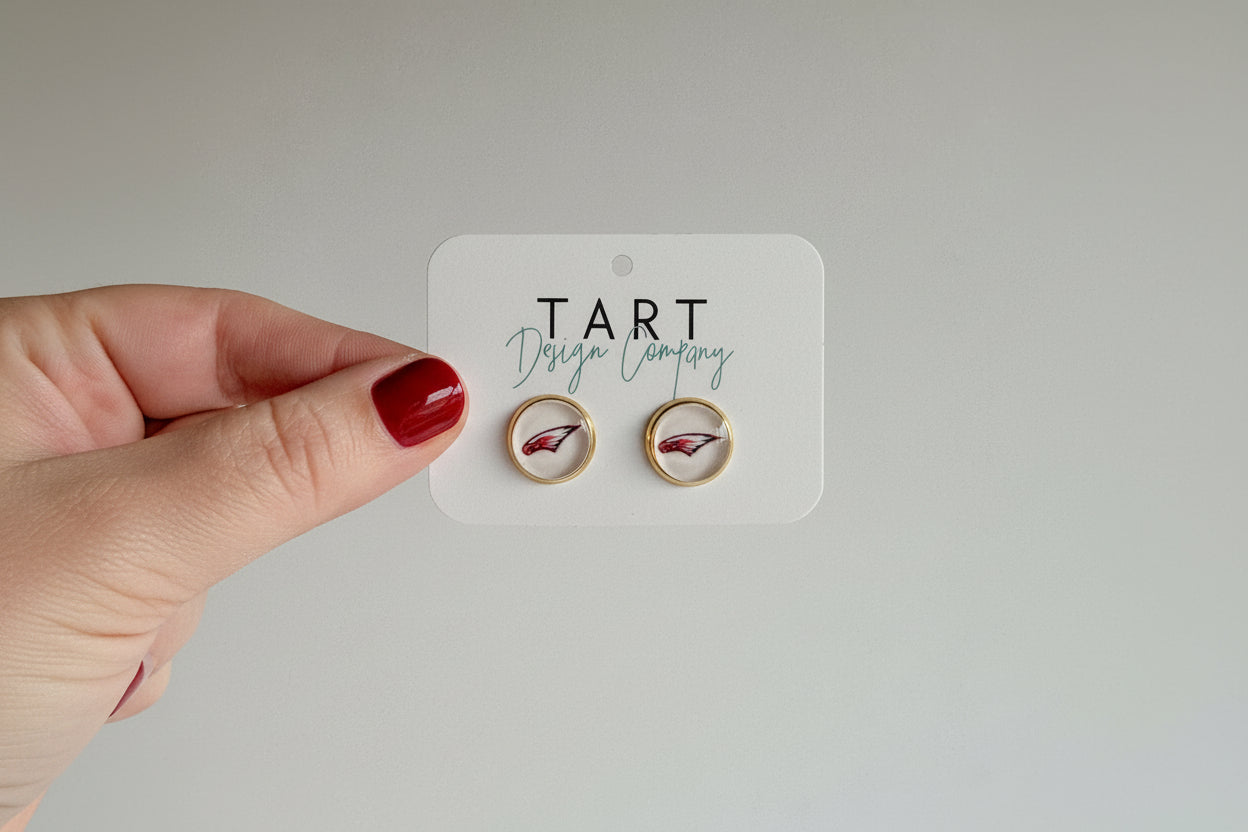 Gold bezel earring studs with white background and image of Maize Eagles logo