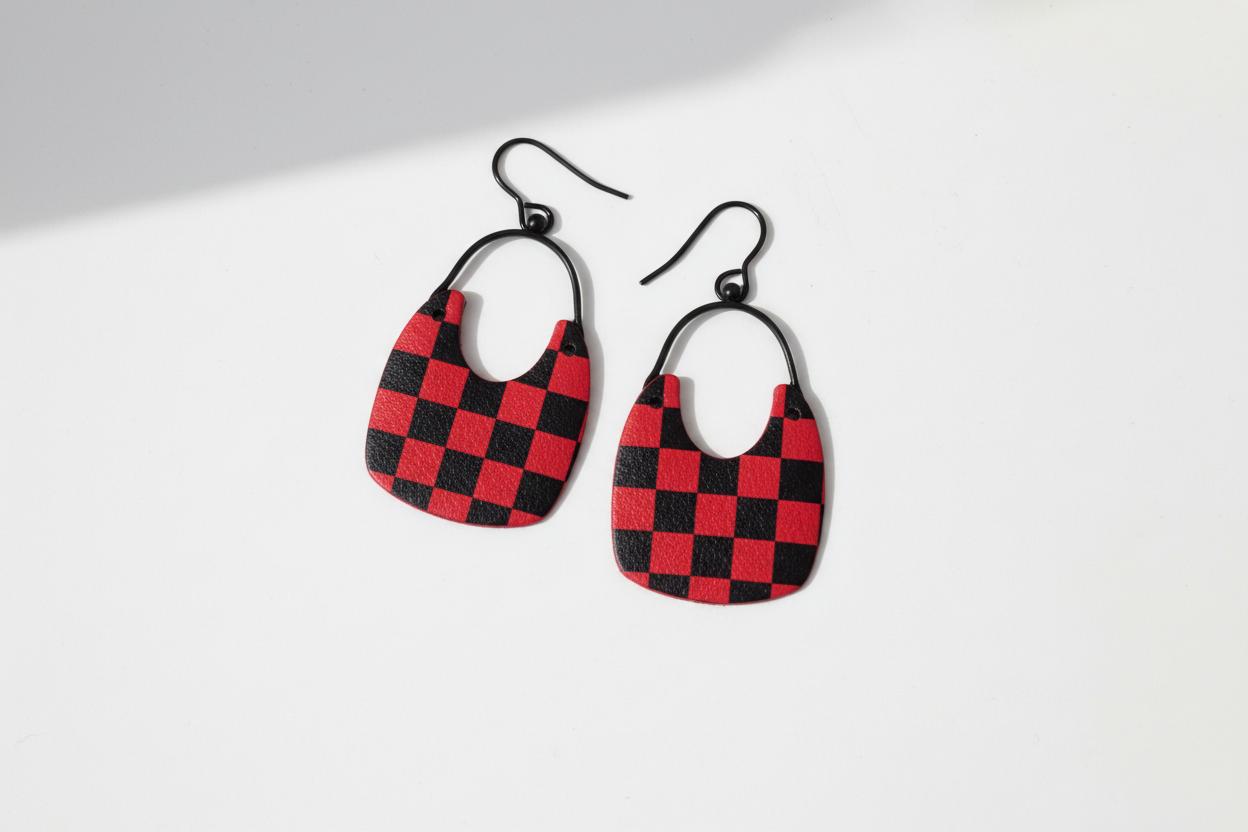 Red and black checkered earrings on a white background