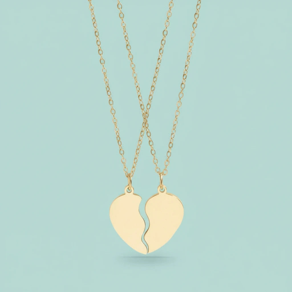 Broken heart shaped pendant necklaces on a light blue background