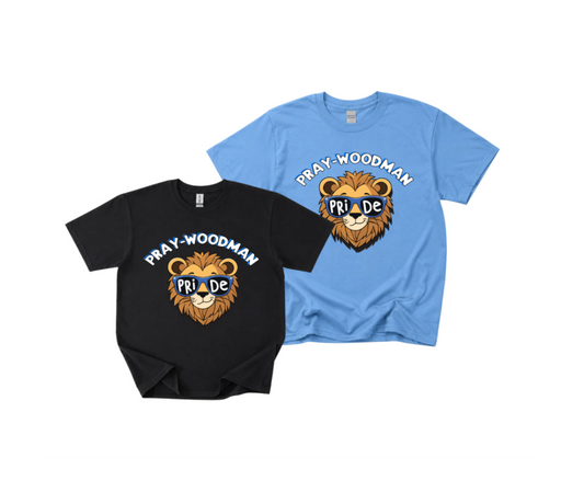 Two graphic t-shirts displayed on a plain white background: one black and one light blue. Both feature a lion head graphic with the words 'PRAY-WOODMAN' above and 'PRIDE' below in a blue banner.